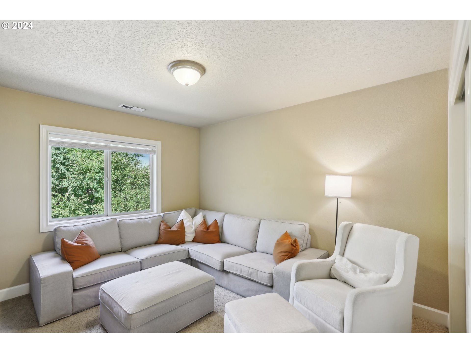 7885 Southwest Daybreak Street Wilsonville, OR 97070 - Photo 34 of 48 a living room with furniture and a large window