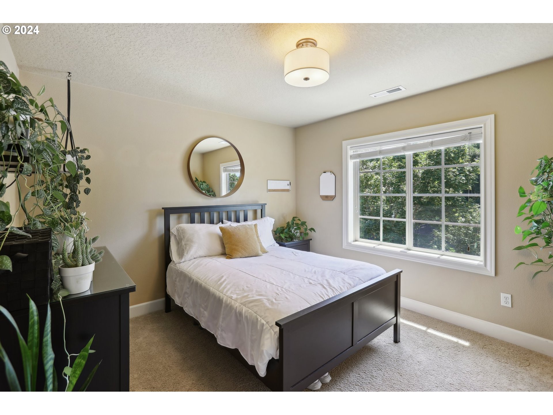 7885 Southwest Daybreak Street Wilsonville, OR 97070 - Photo 36 of 48 a bedroom with a bed and a window