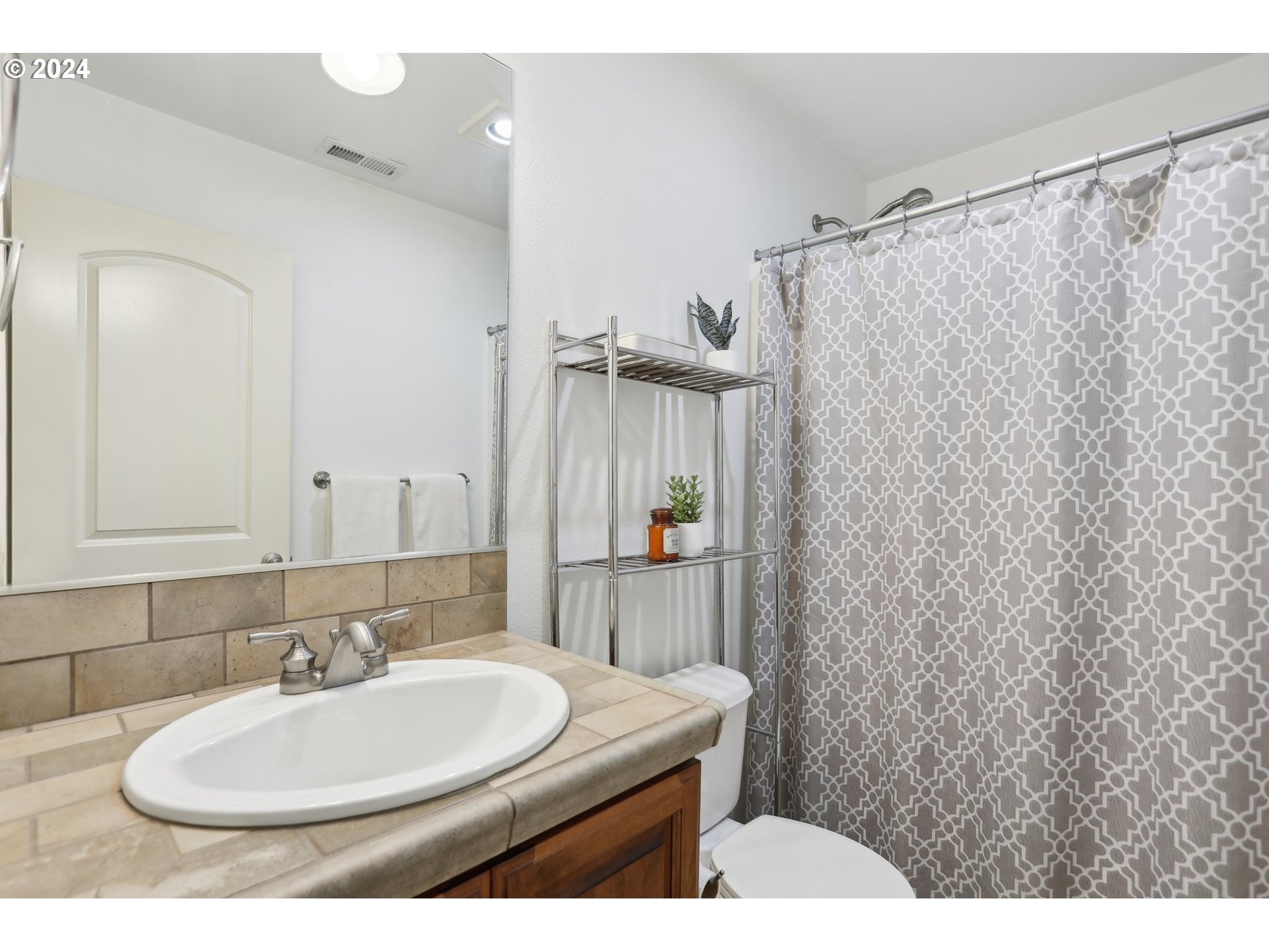 7885 Southwest Daybreak Street Wilsonville, OR 97070 - Photo 37 of 48 a bathroom with a sink a toilet and shower