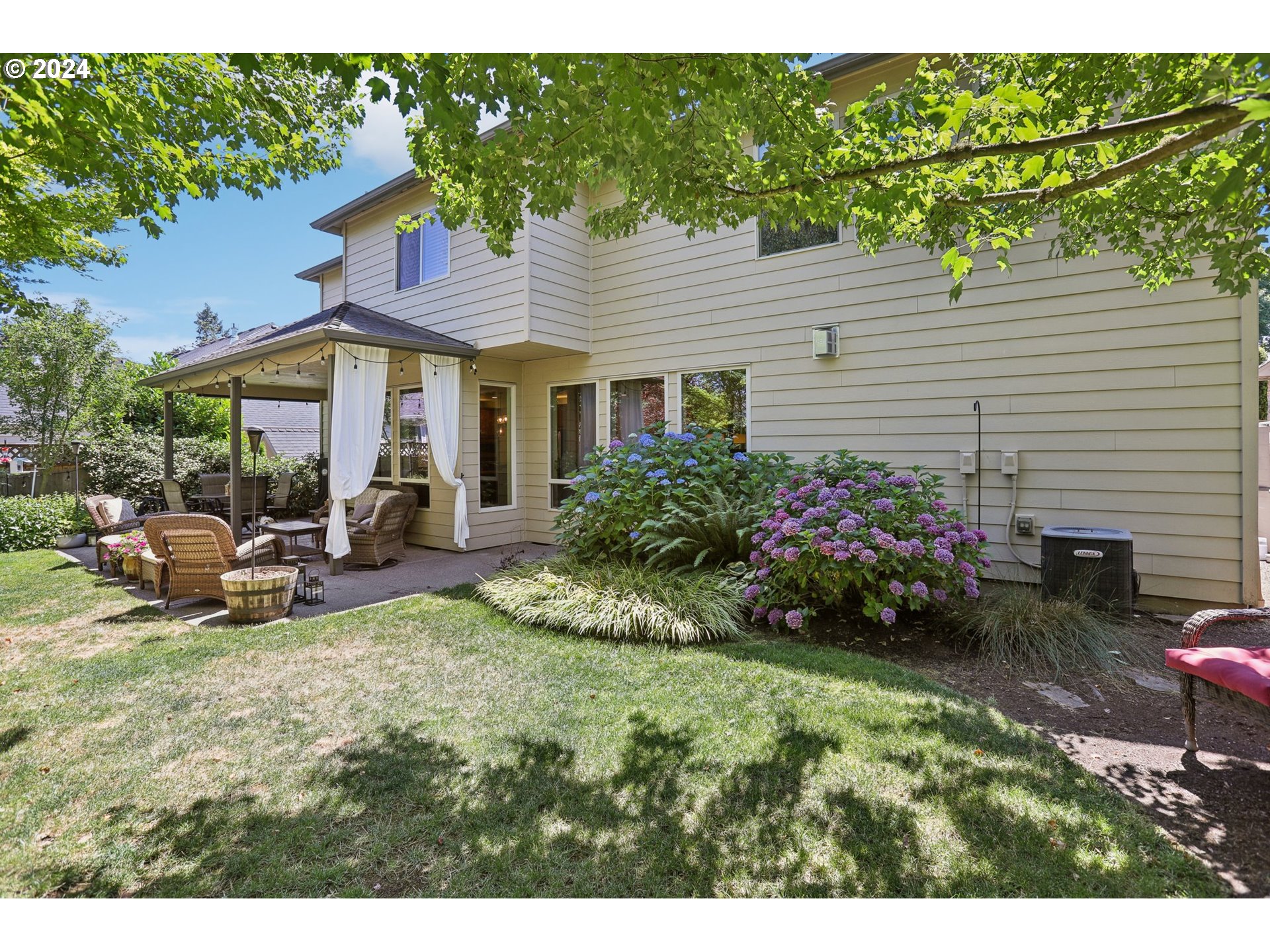 7885 Southwest Daybreak Street Wilsonville, OR 97070 - Photo 45 of 48 a view of a house with backyard sitting area and garden