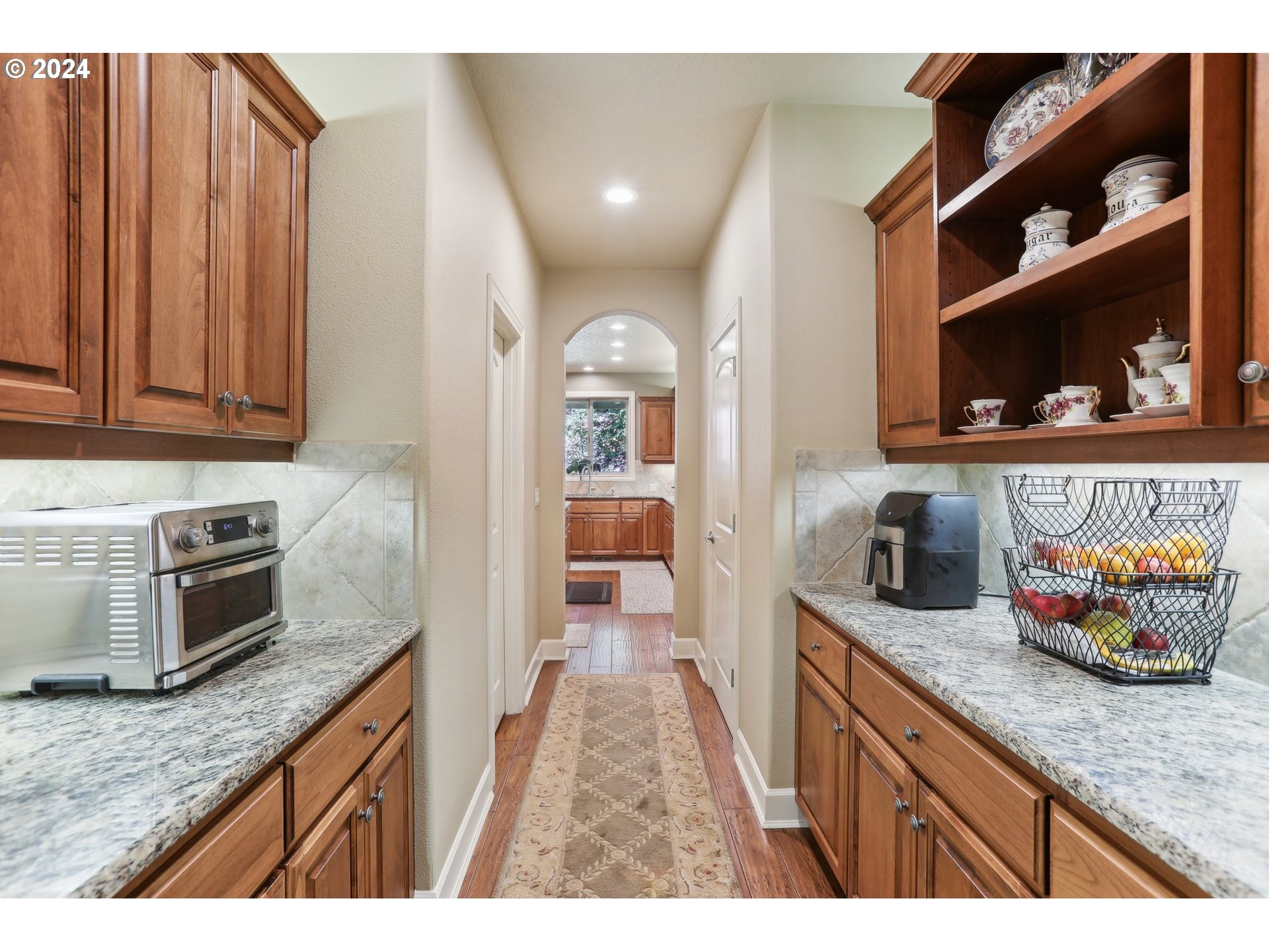 7885 Southwest Daybreak Street Wilsonville, OR 97070 - Photo 7 of 48 a kitchen with granite countertop cabinets and window