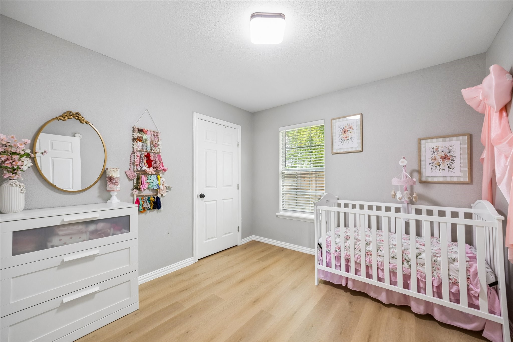 539 Anderson Street Sealy, TX 77474 - Photo 14 of 19 This secondary bedroom features light gray walls and warm wood flooring.
