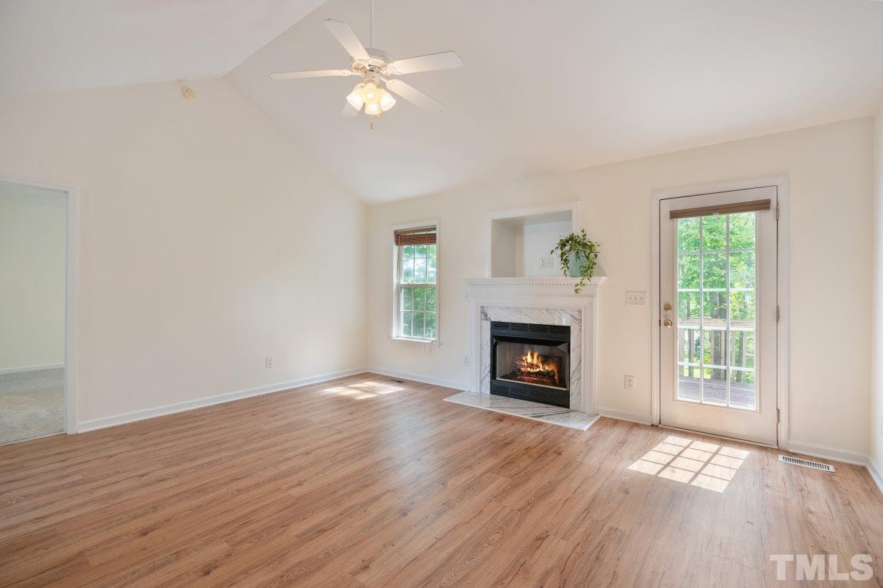 616 Rookwood Court Wake Forest, NC 27587 - Photo 11 of 30 an empty room with windows a fireplace
