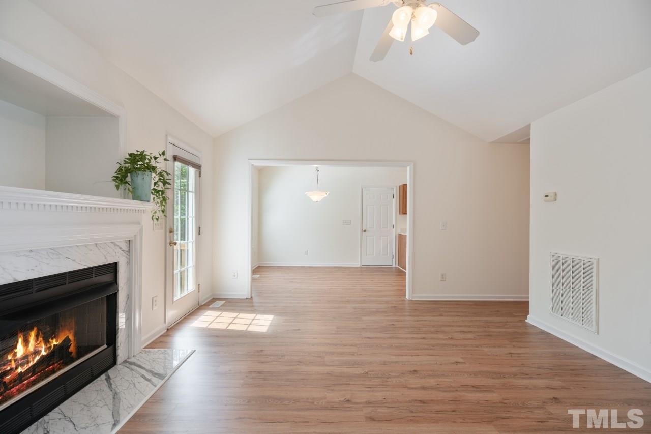 616 Rookwood Court Wake Forest, NC 27587 - Photo 12 of 30 a view of an empty room with wooden floor fireplace and a window