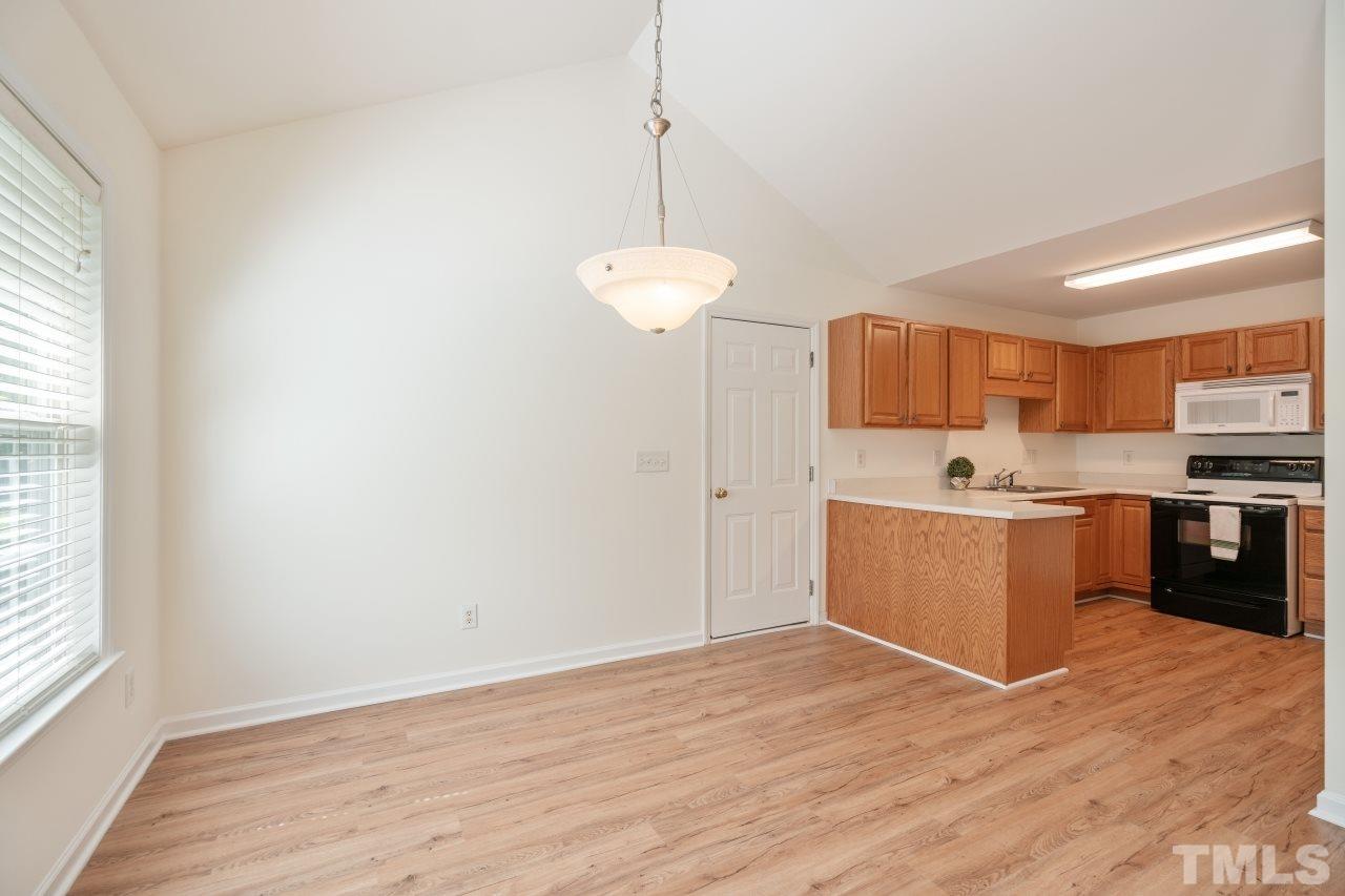 616 Rookwood Court Wake Forest, NC 27587 - Photo 14 of 30 a kitchen with a refrigerator and a sink