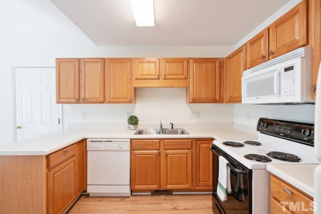 616 Rookwood Court Wake Forest, NC 27587 - Photo 16 of 30 a kitchen with a sink a stove and cabinets