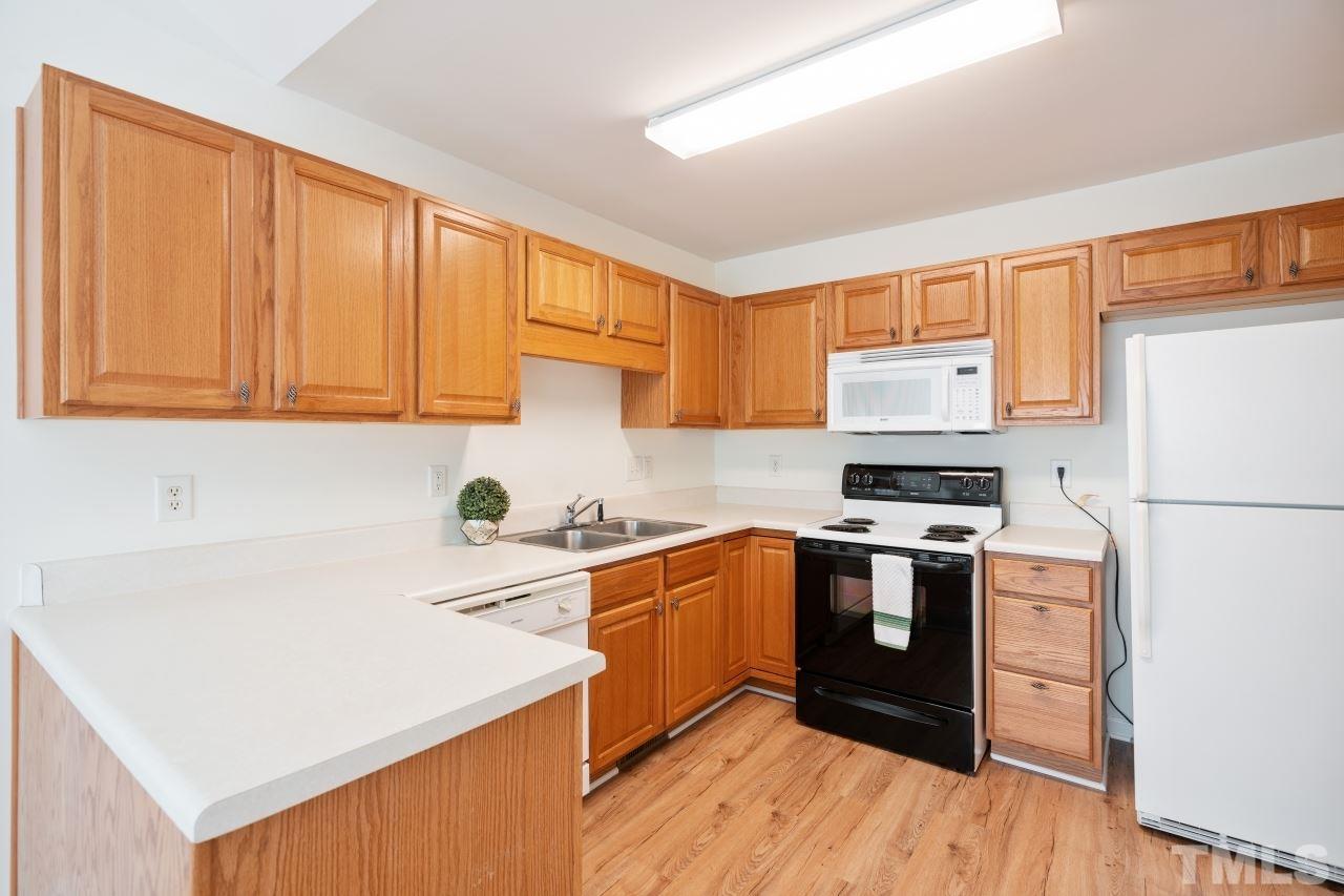 616 Rookwood Court Wake Forest, NC 27587 - Photo 17 of 30 a kitchen with a sink a stove and cabinets