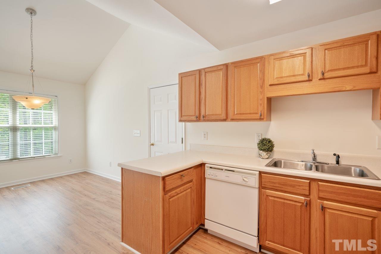 616 Rookwood Court Wake Forest, NC 27587 - Photo 18 of 30 a kitchen with a sink cabinets and wooden floor