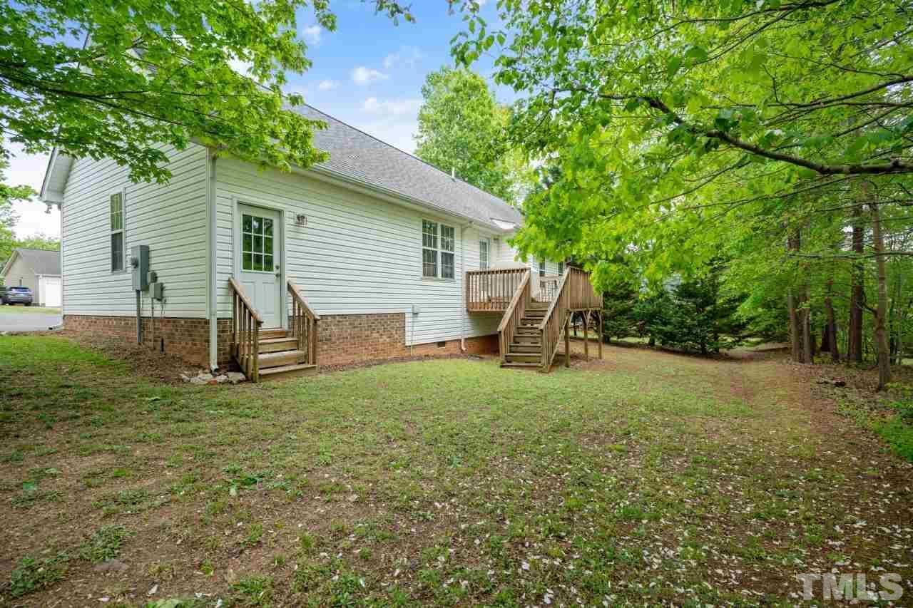 616 Rookwood Court Wake Forest, NC 27587 - Photo 5 of 30 a view of a backyard with a garden and entertaining space