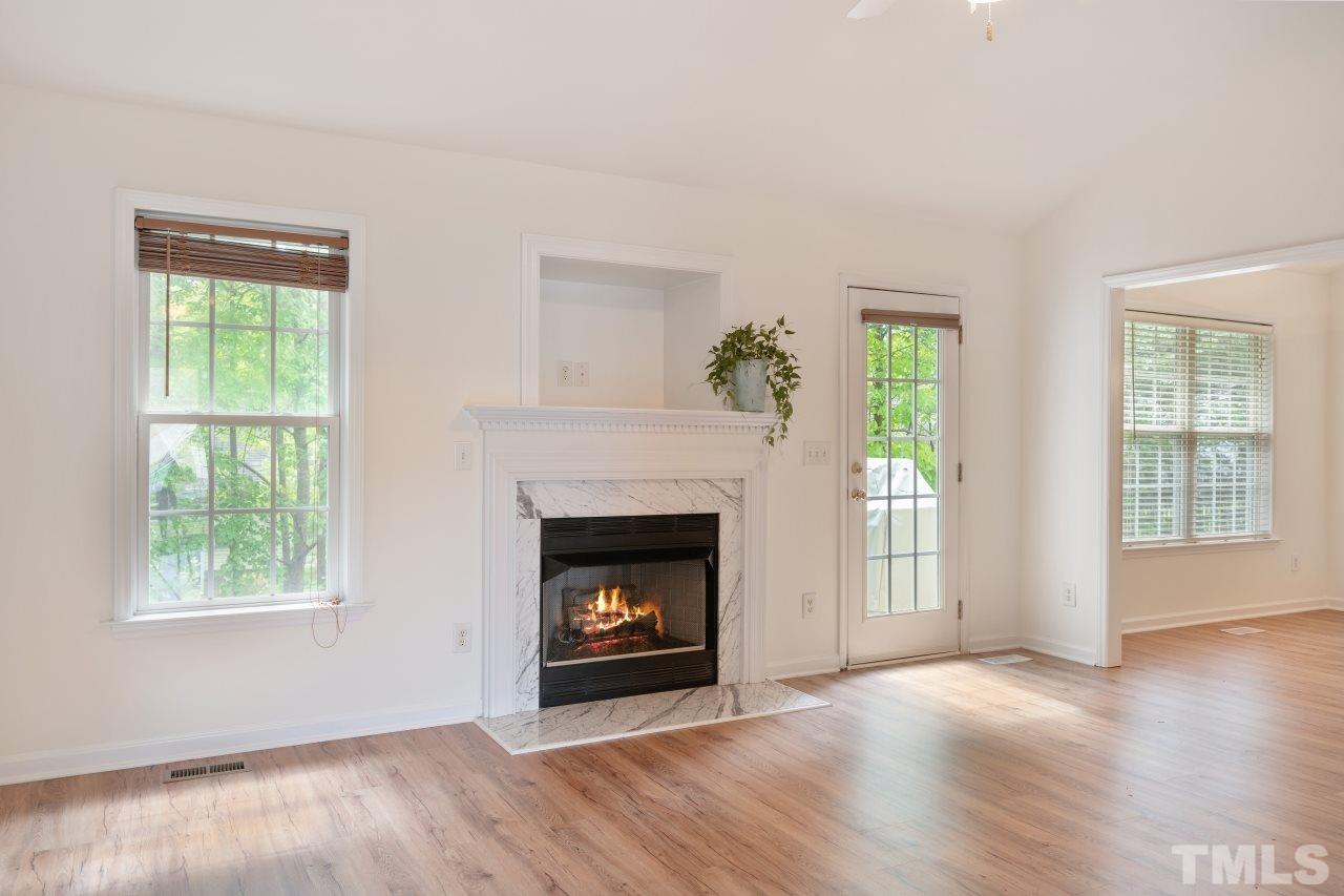 616 Rookwood Court Wake Forest, NC 27587 - Photo 9 of 30 a view of an empty room with wooden floor and a window