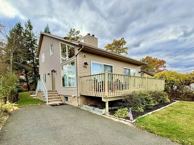 a view of a house with a small yard and wooden fence