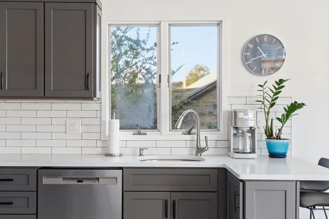 a kitchen with a sink a counter space and a window