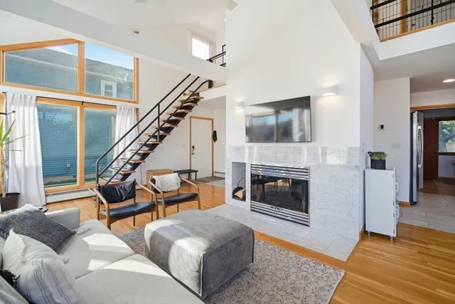 a living room with furniture and a fireplace