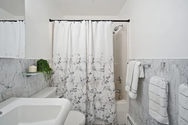 a bathroom with a bathtub and shower
