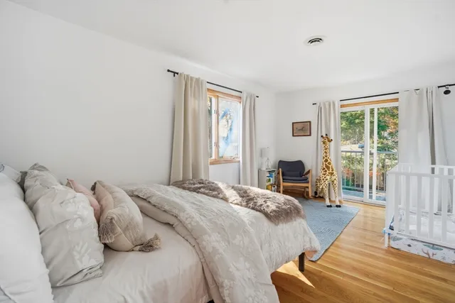 a spacious bedroom with a bed and a large window