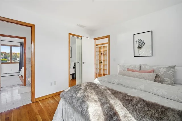 a bedroom with a bed and a painting on the wall