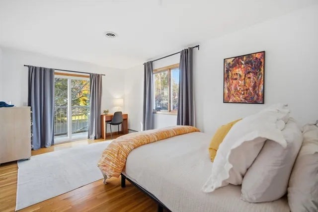 a bed sitting in a bedroom next to a window