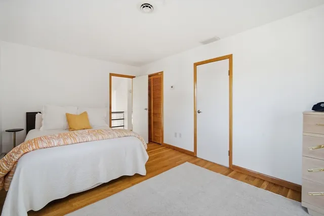 a bedroom with a bed and a closet