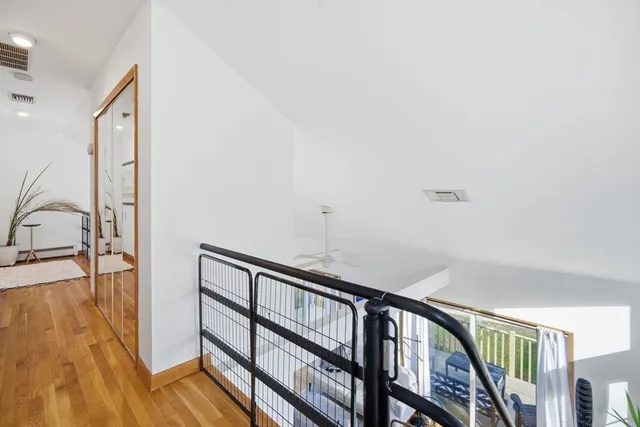 a view of staircase with white walls and a window