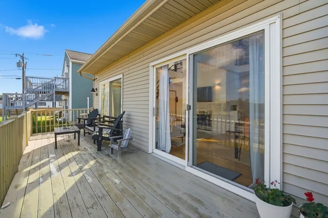 a view of balcony with chairs potted plants with wooden floor