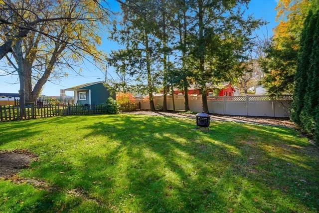 a tree in front of a white house