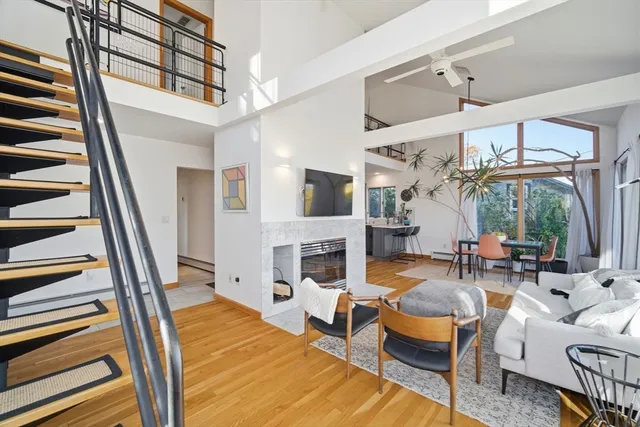 a living room with fireplace furniture and a floor to ceiling window
