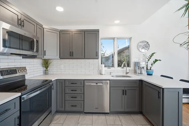 a kitchen with a sink stove and microwave