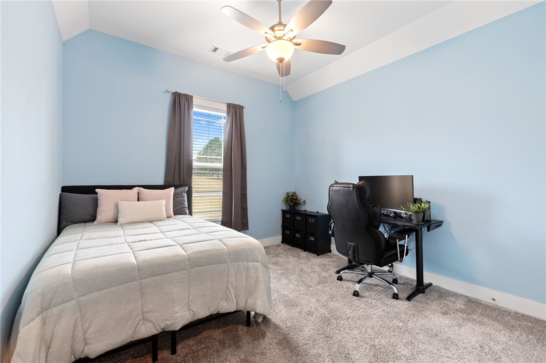 1050 Old Dacusville Road Easley, SC 29640 - Photo 21 of 33 This cozy bedroom features a vaulted ceiling and soft carpet underfoot, creating a serene and inviting atmosphere.
