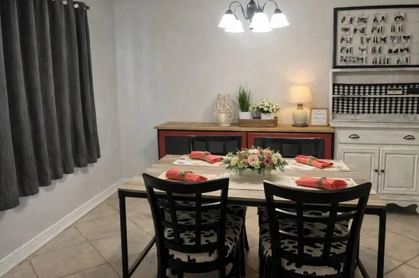 a view of a dining room with furniture and chandelier