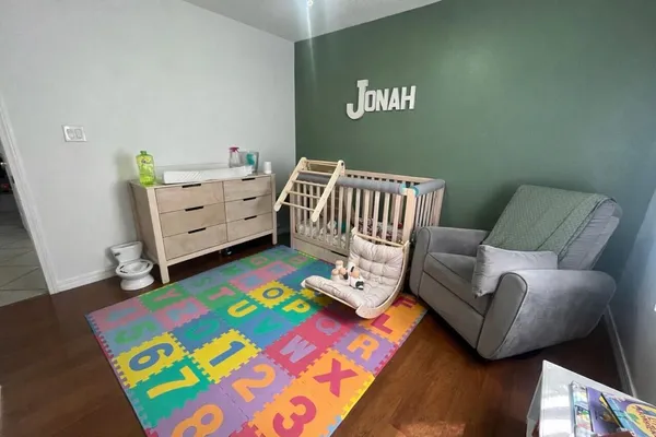 a bedroom with furniture and a wooden floor
