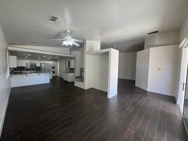 a view of empty room with wooden floor