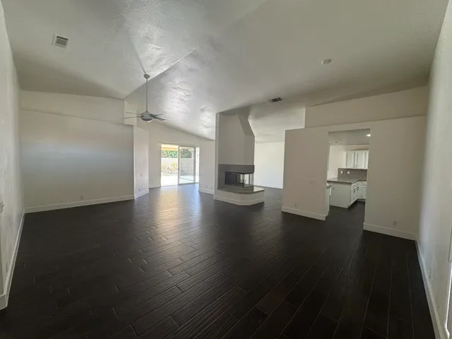 a utility room with wooden floor washer and dryer