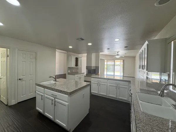 a kitchen with a sink stove and cabinets
