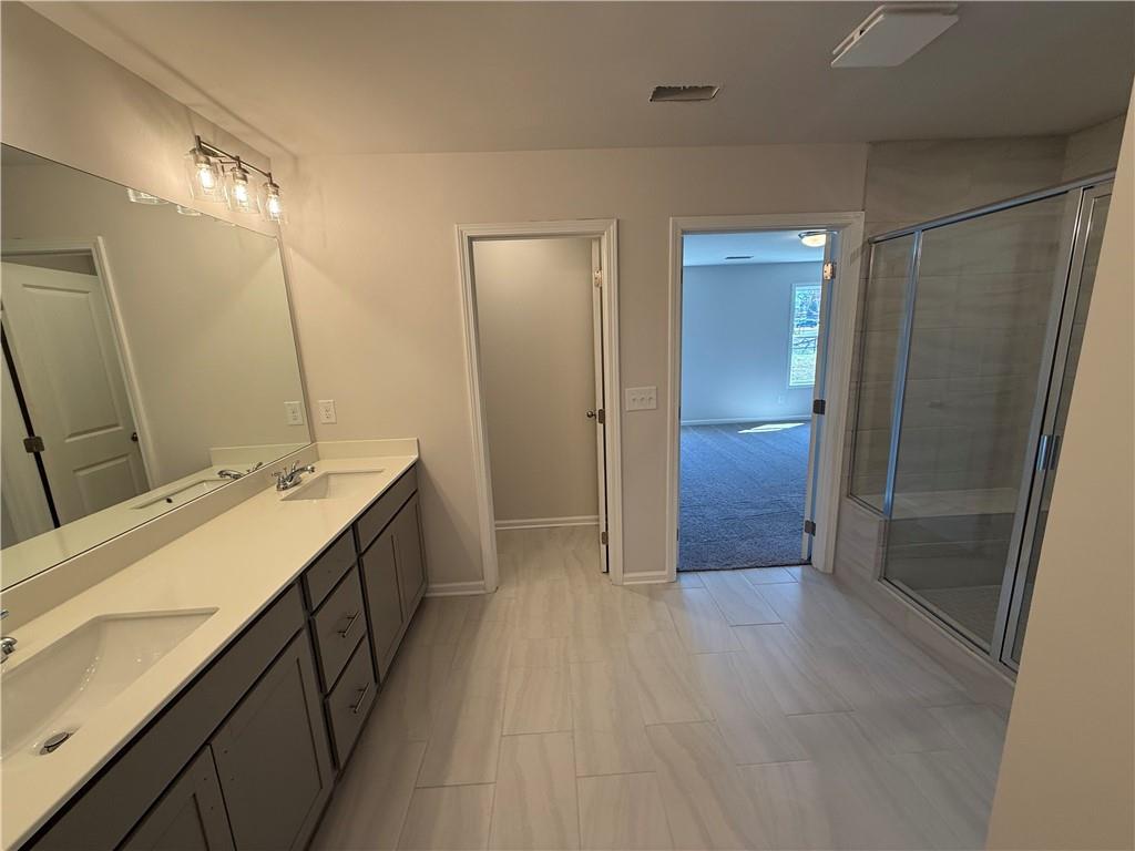 5143 Longview Run Decatur, GA 30035 - Photo 9 of 17 a bathroom with a double vanity sink and a mirror