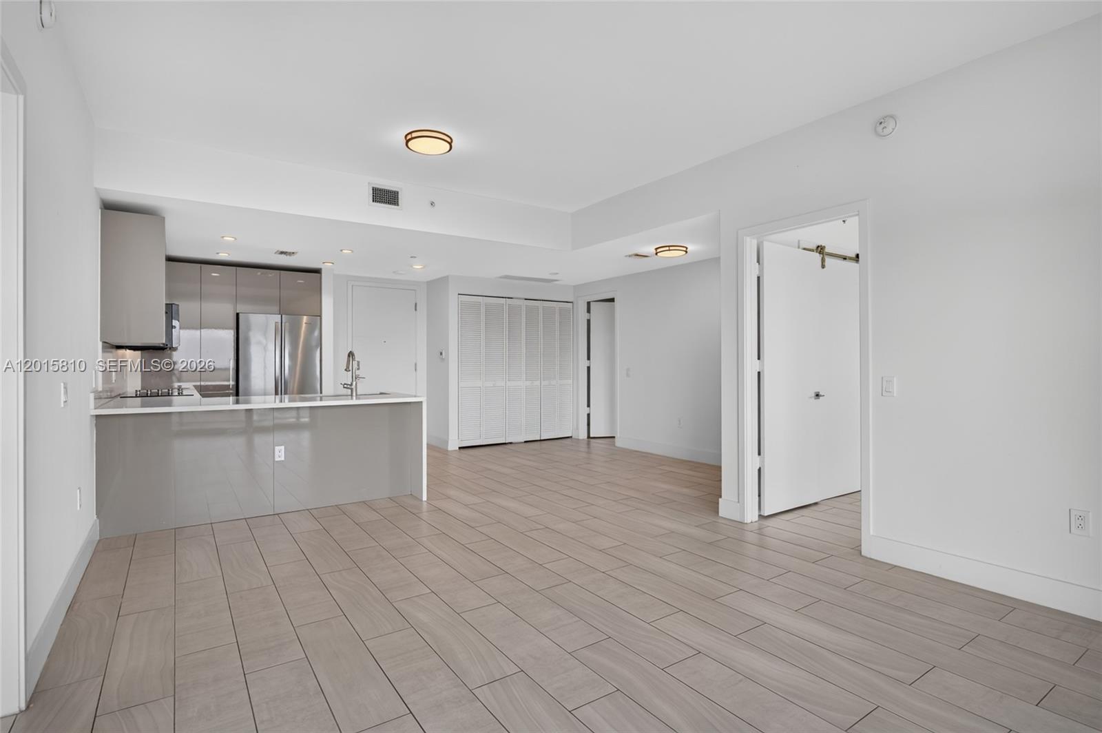 2000 Metropica Way, Unit 1902 Sunrise, FL 33323 - Photo 10 of 40 a view of kitchen with stainless steel appliances cabinets and wooden floor