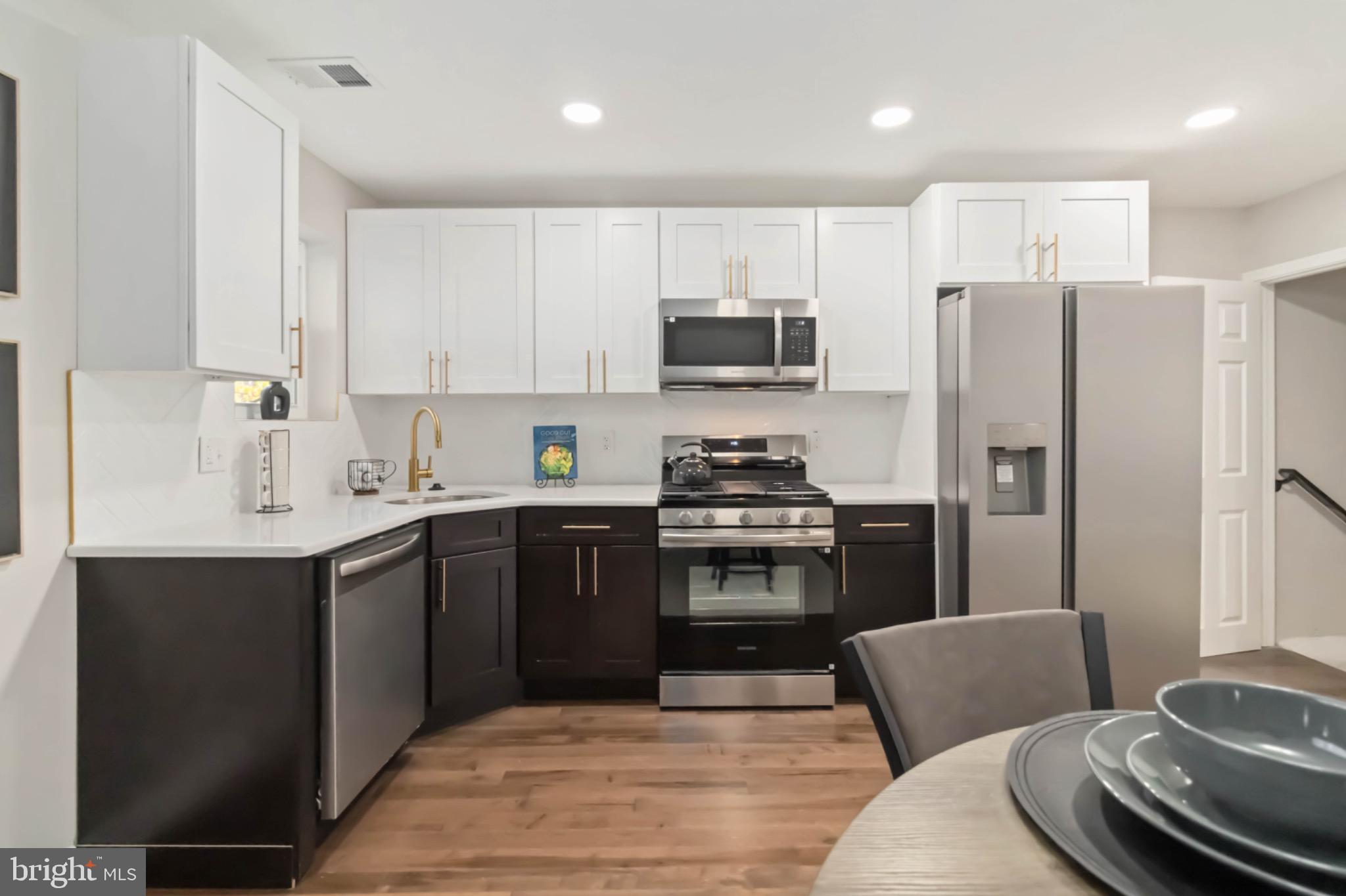 7724 Fayette Street Philadelphia, PA 19150 - Photo 14 of 33 a kitchen with stainless steel appliances a refrigerator stove microwave and sink