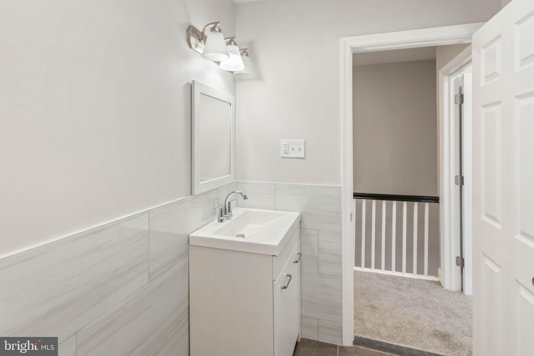 7724 Fayette Street Philadelphia, PA 19150 - Photo 21 of 33 a bathroom with a sink a light fixture and a mirror