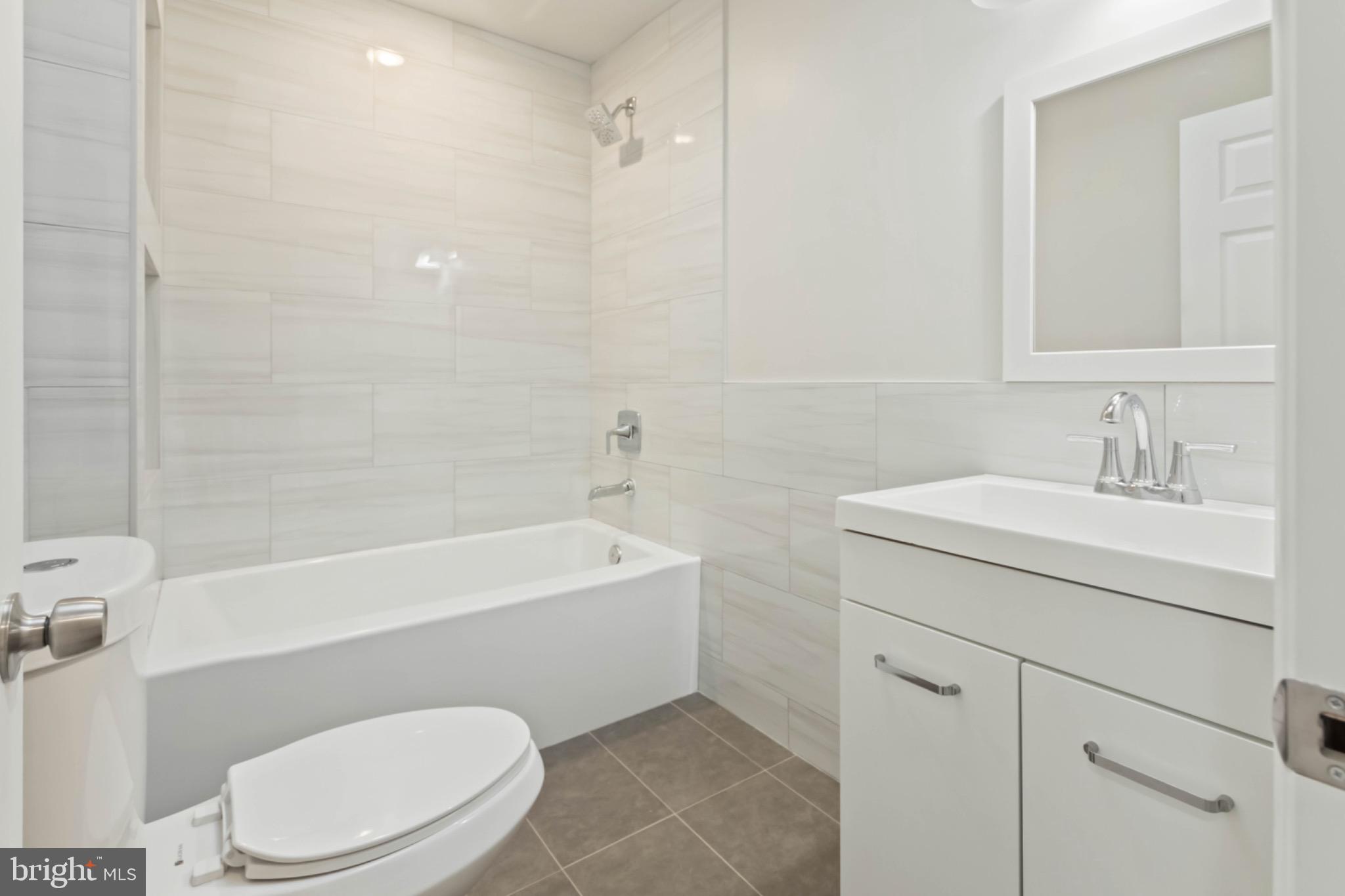 7724 Fayette Street Philadelphia, PA 19150 - Photo 22 of 33 a bathroom with a sink a mirror a toilet and bathtub