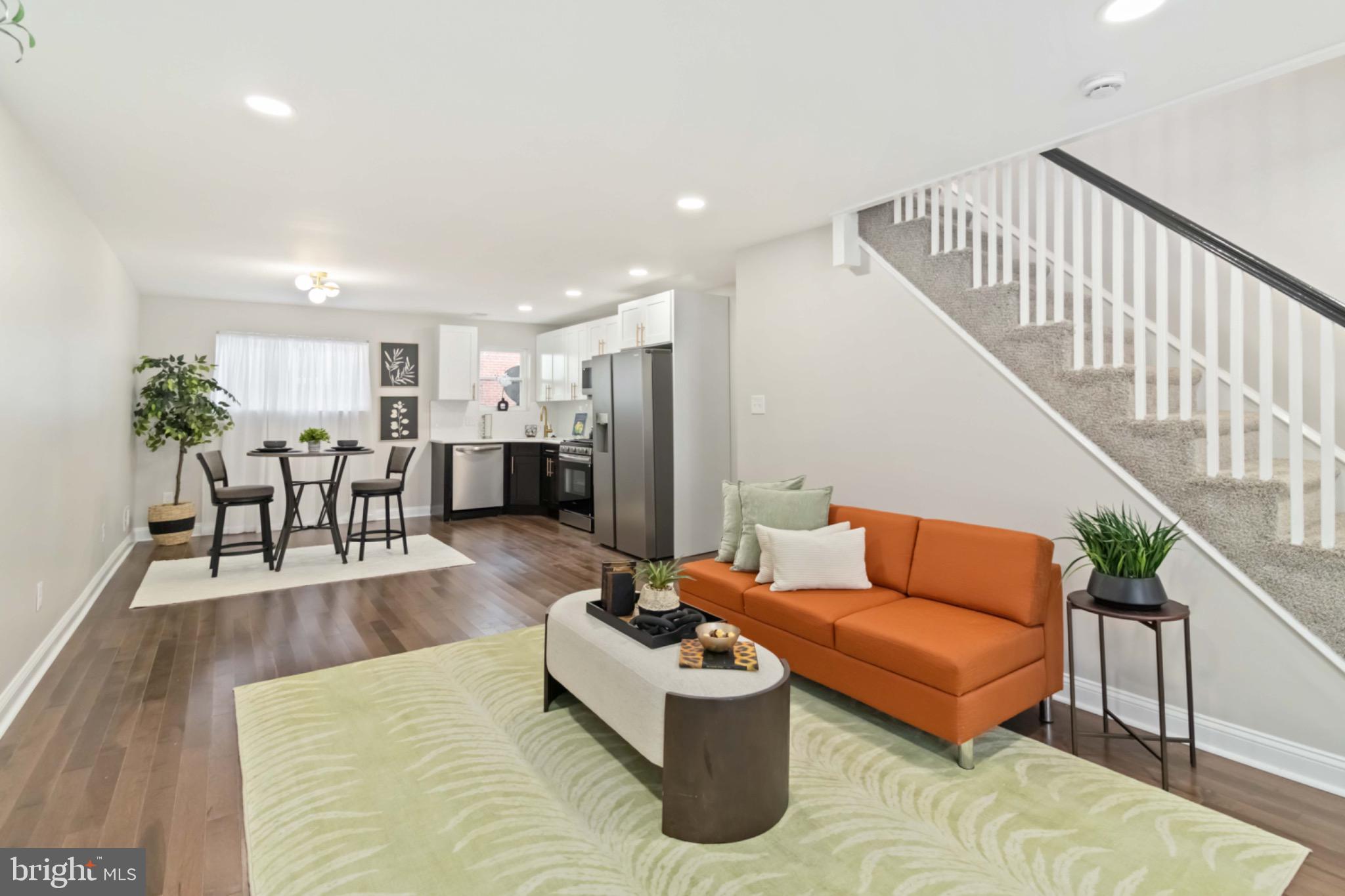 7724 Fayette Street Philadelphia, PA 19150 - Photo 6 of 33 a living room with furniture and kitchen view with wooden floor