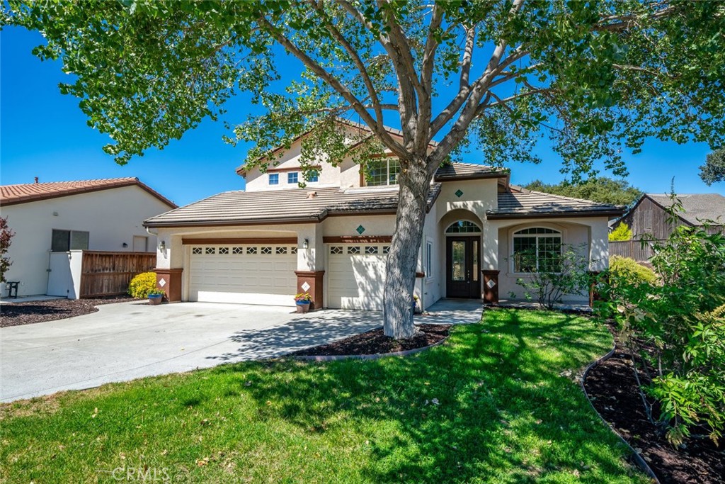 a view of a house with garden and sitting area
