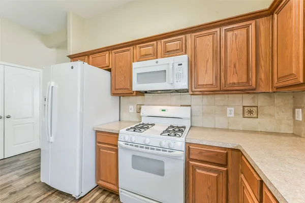 a kitchen with stainless steel appliances granite countertop a sink a stove and cabinets