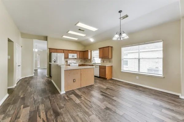 a kitchen with stainless steel appliances granite countertop a refrigerator sink and stove