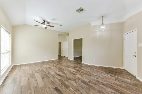 wooden floor in an empty room with a window