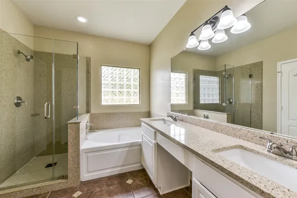 a bathroom with a tub sink and mirror