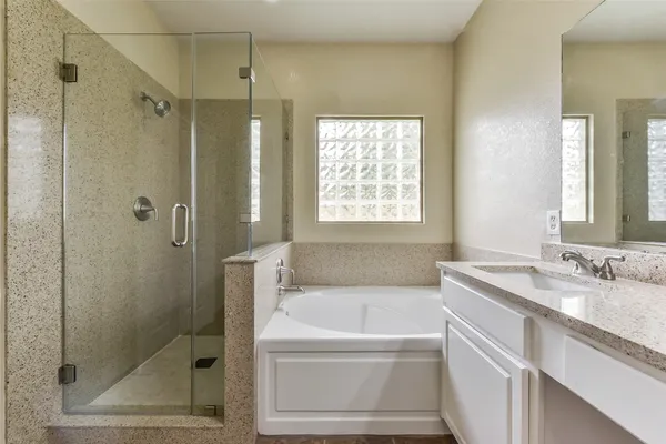 a bathroom with a granite countertop sink mirror and shower