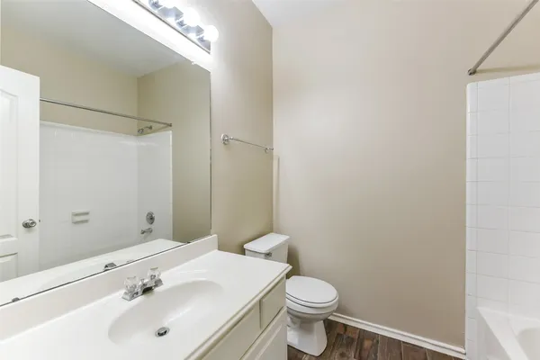 an empty room with fan and entrance