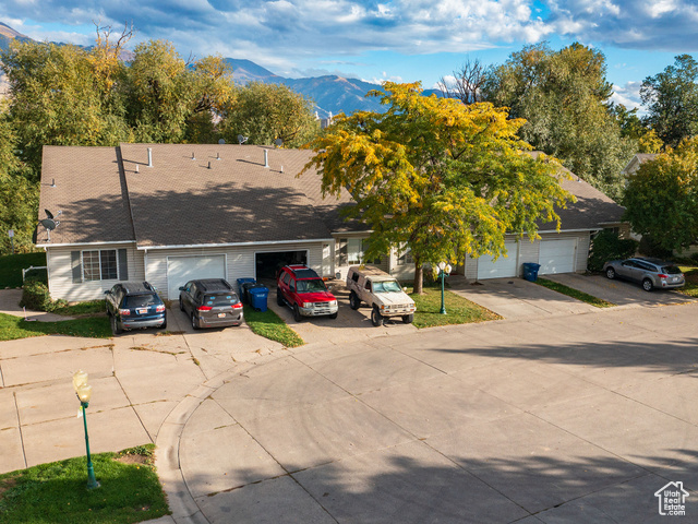 190 West 700 North Logan, UT 84321 - Photo 11 of 51 View of front facade with a mountain view, driveway, and roof with shingles