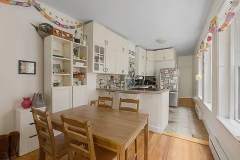 a kitchen with a table and chairs in it