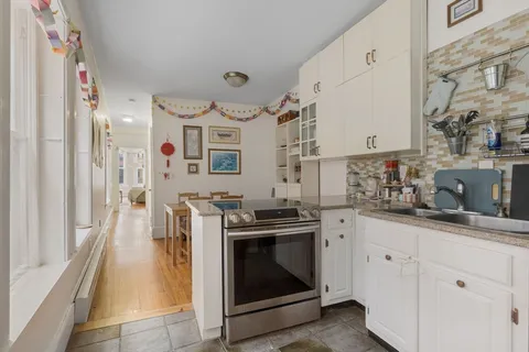 a kitchen with stainless steel appliances granite countertop a stove and a sink