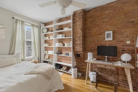 a bedroom with a bed and a desk